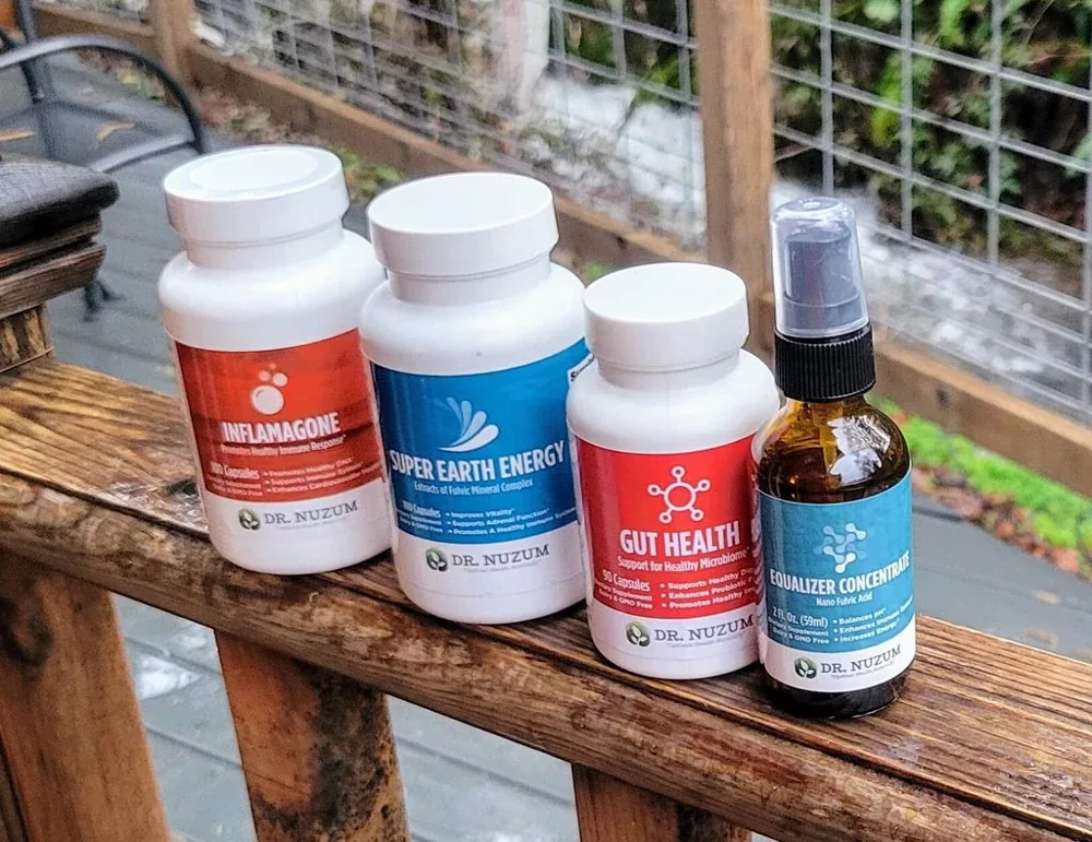 Four Dr. Nuzum bottles lined up on a wooden deck rail, photographed by a customer